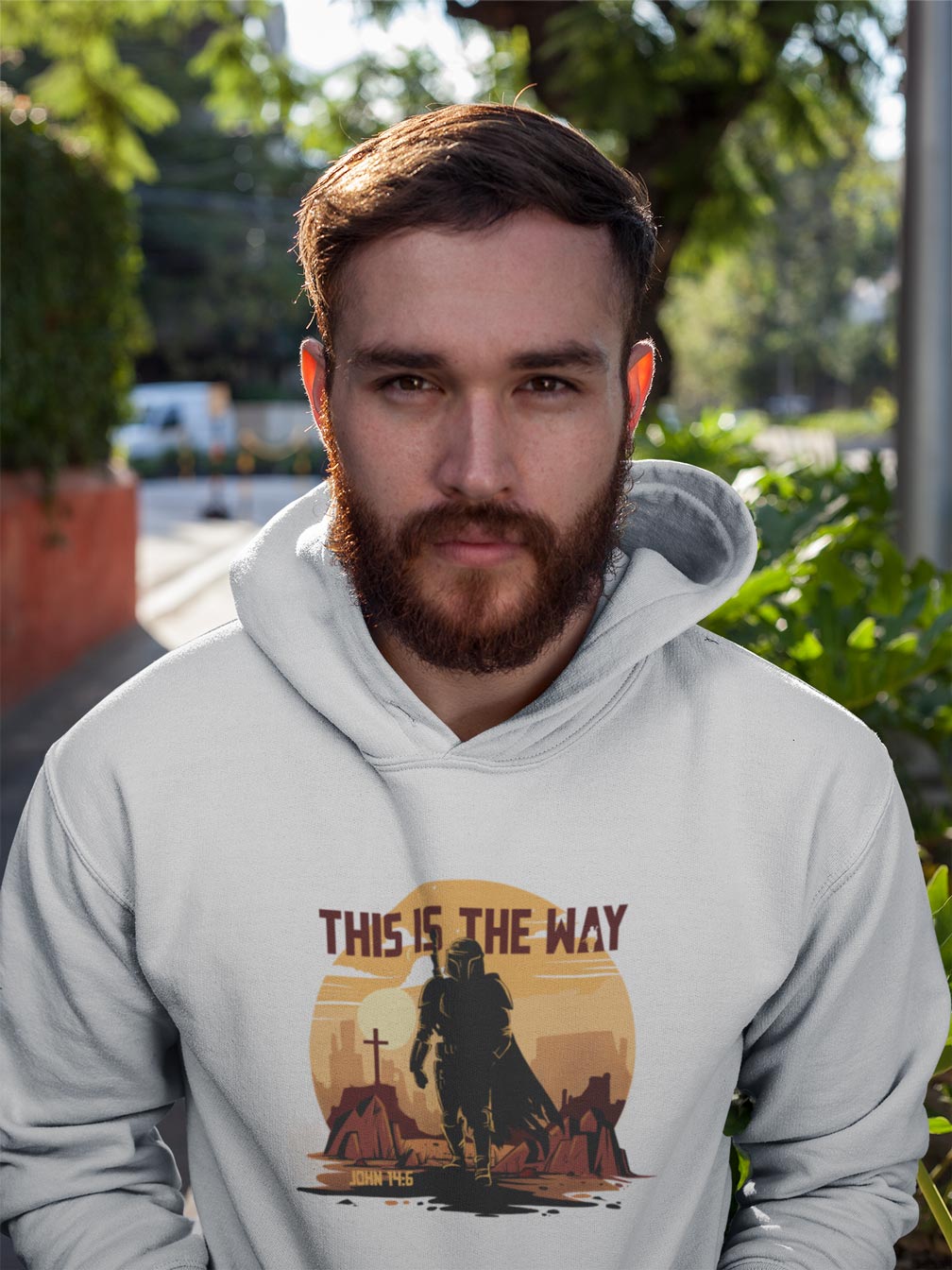 Man wearing a hoodie with a 'This is the Way' design outdoors