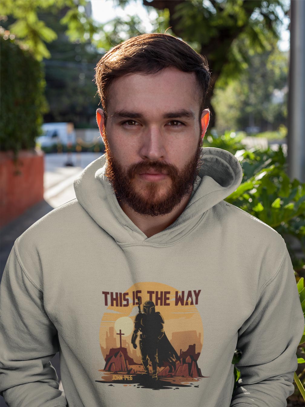 Man wearing a hoodie with 'This is the Way' design outdoors